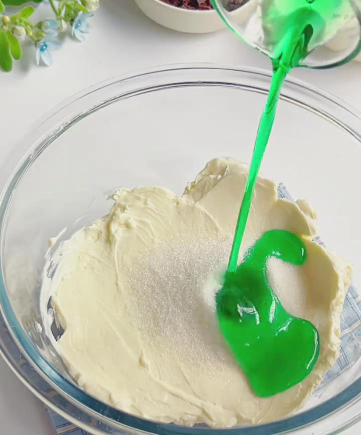 In a bowl, combine softened cream cheese, granulated sugar, and mint syrup