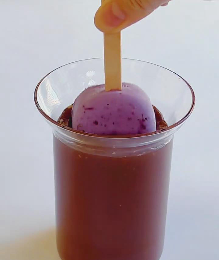 Quickly dip each popsicle into the chocolate mixture to coat evenly new