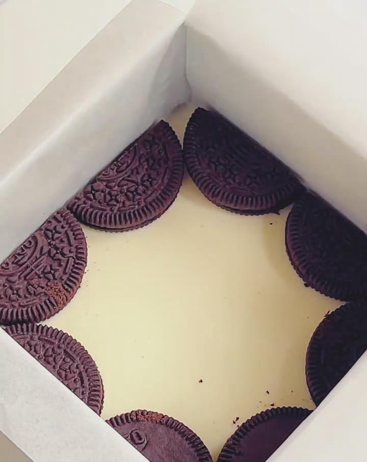 Place whole Oreos evenly on the first cheesecake layer