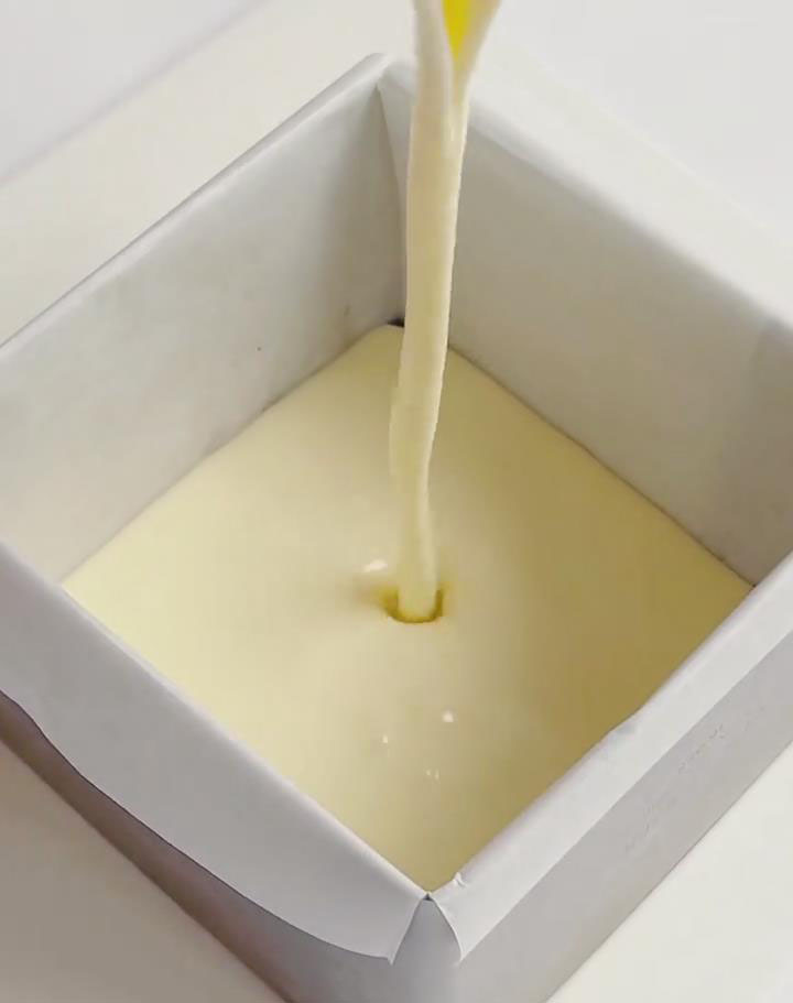 Pour half of the batter over the biscuit base