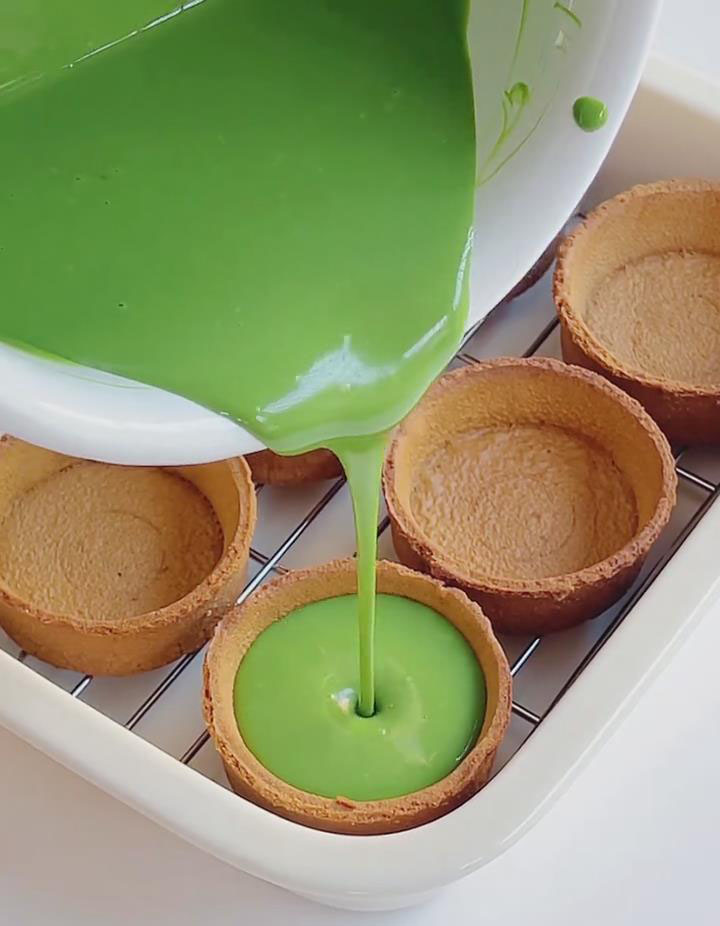 Pour the prepared filling evenly into the tart shells