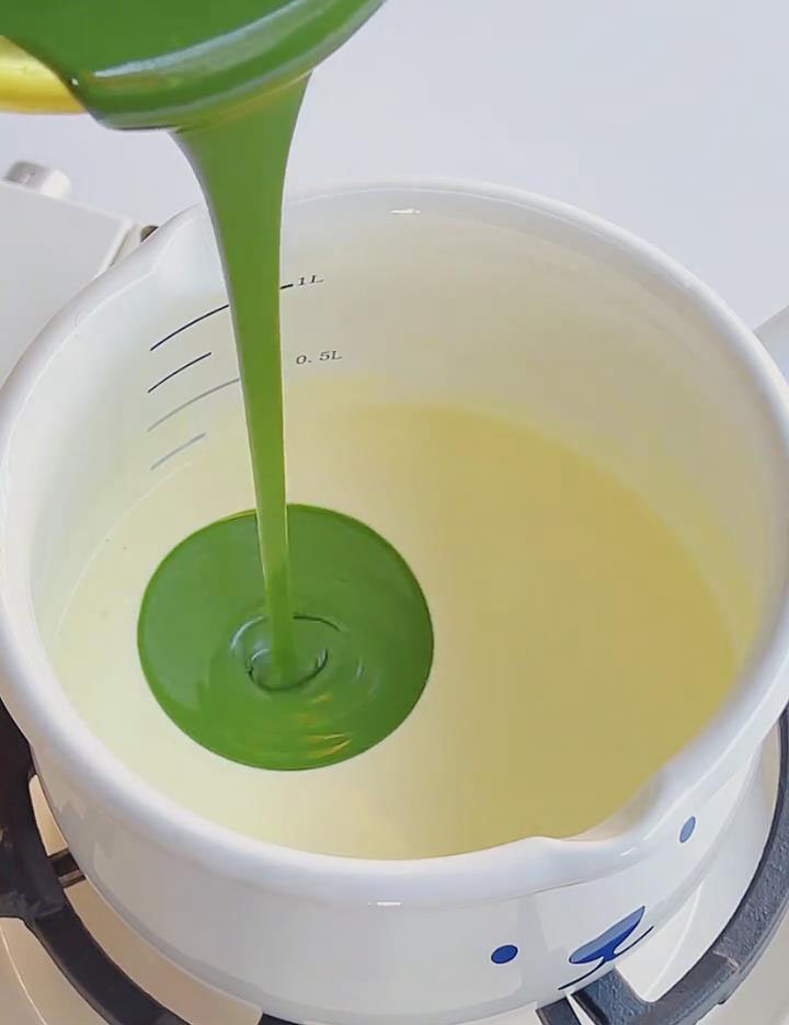 pour the matcha chocolate mixture into the warm cream