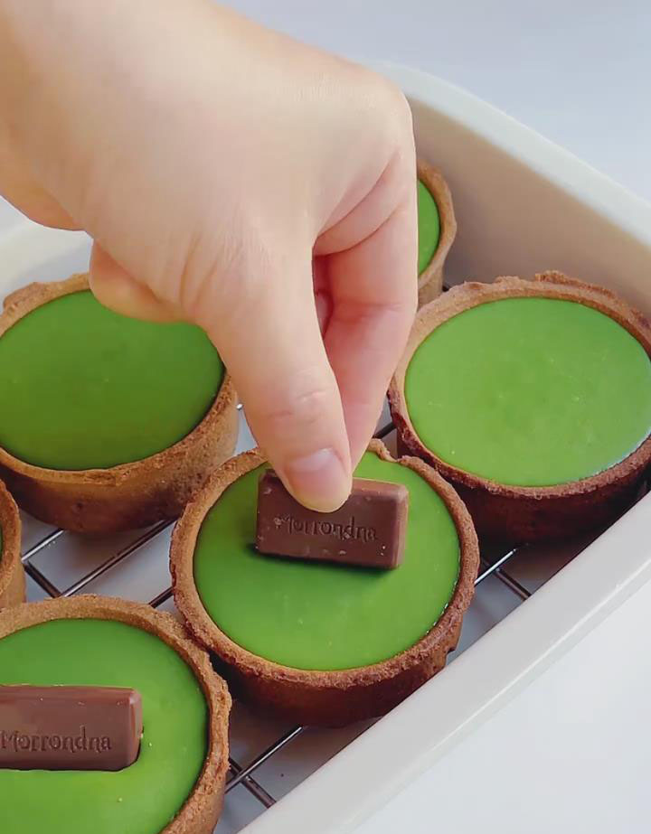 top each with a small piece of black chocolate for decoration