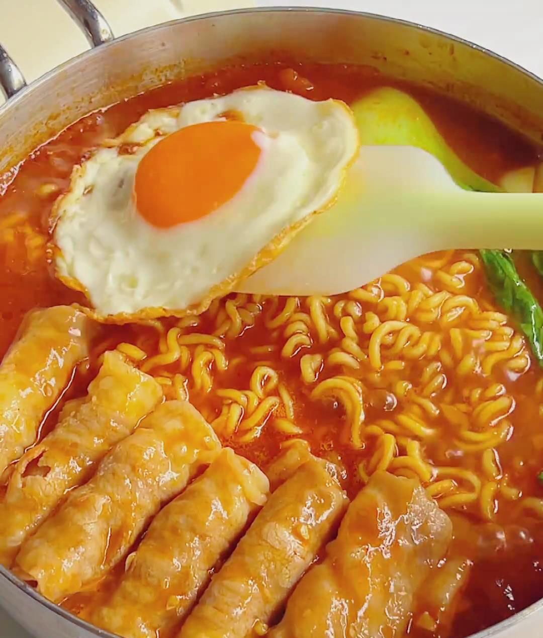 Add beef slices and greens