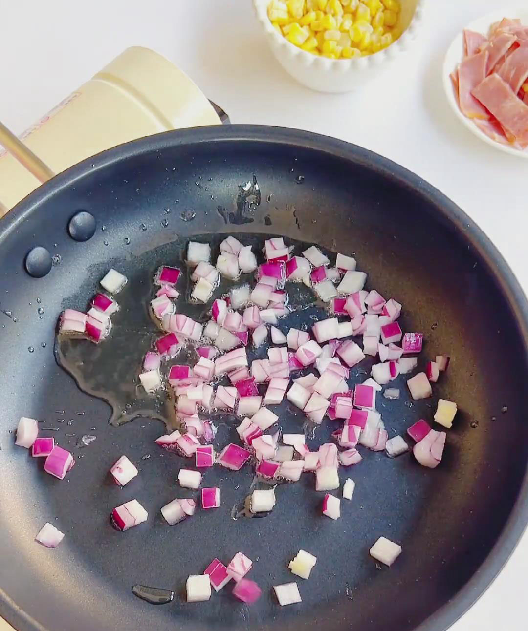 Add the diced onion and sauté constantly with a silicone spatula