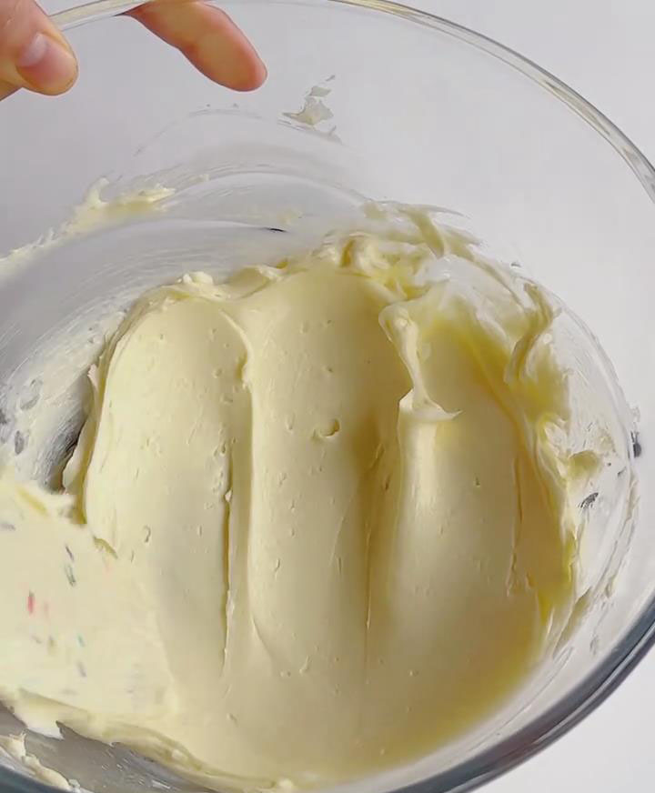 Beat softened cream cheese with sugar until smooth