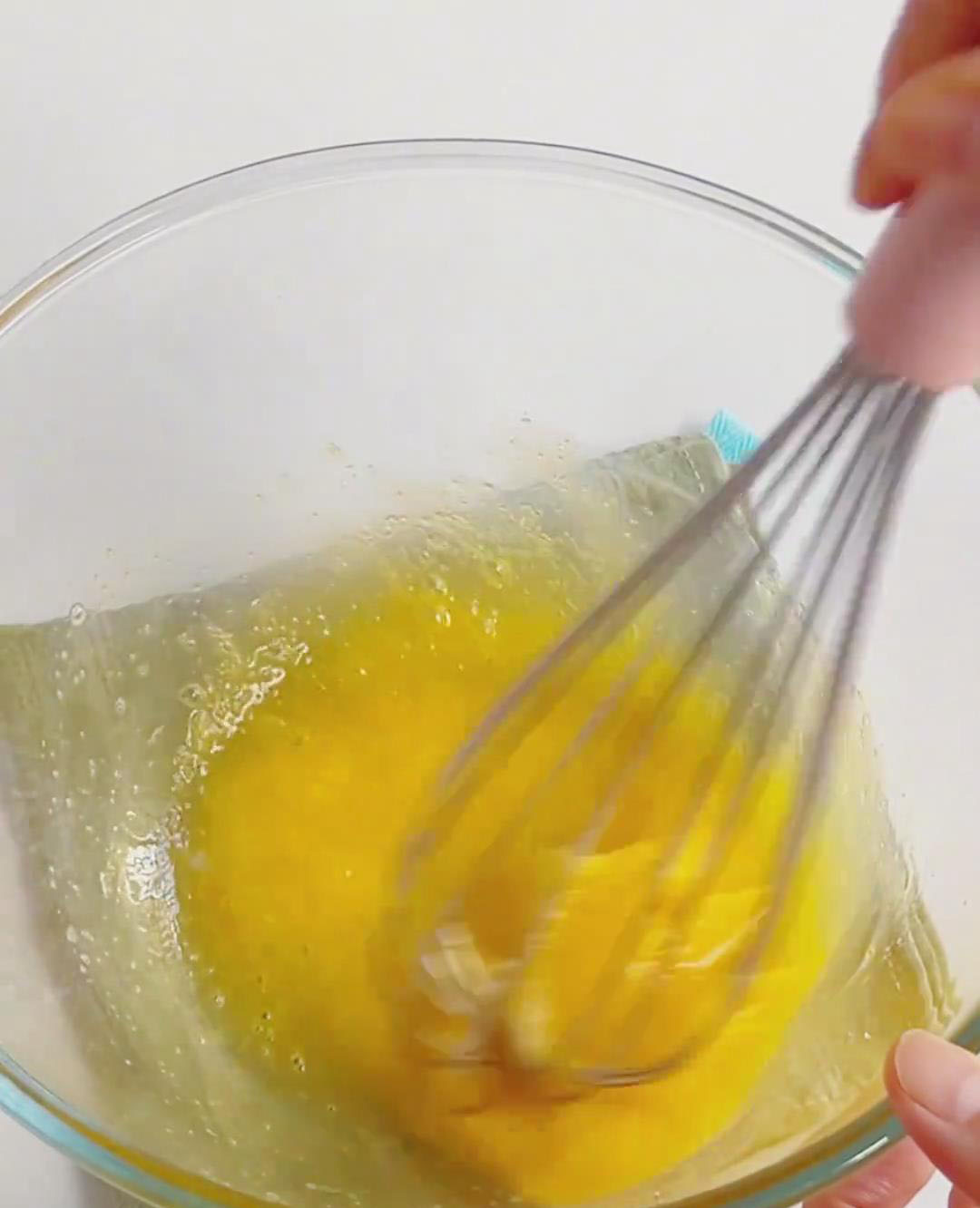 Crack the egg into a clean bowl, add sugar, and whisk gently until dissolved