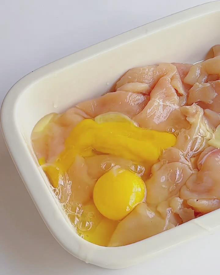 Crack the eggs into the bowl with the chicken