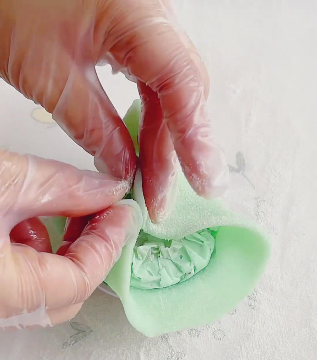 Gather the edges of the mochi toward the middle