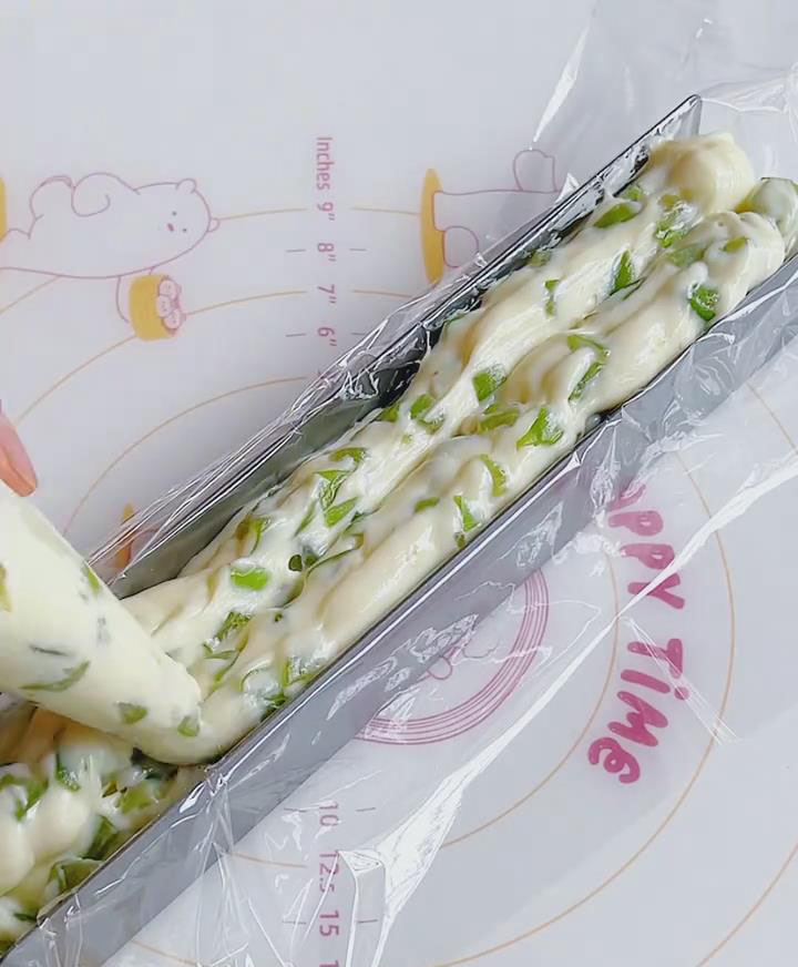 Line a mold with plastic wrap and pipe into a log shape