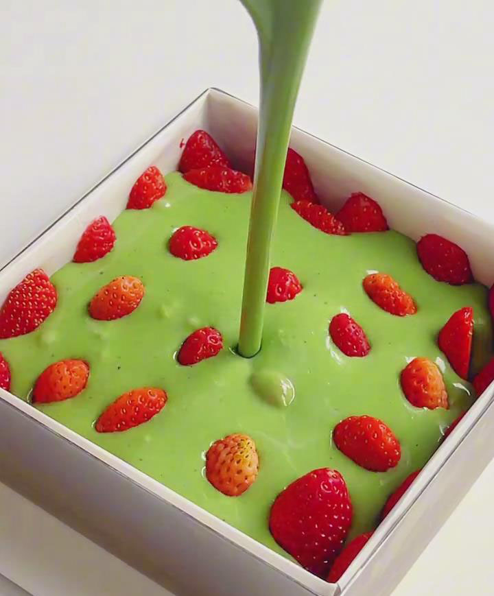 Pour the matcha filling mixture over the strawberries
