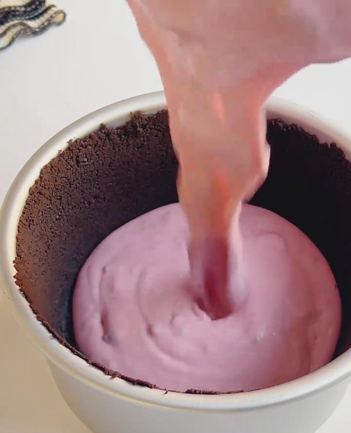 Slowly pour the prepared (and optionally strained) mousse mixture into the pan