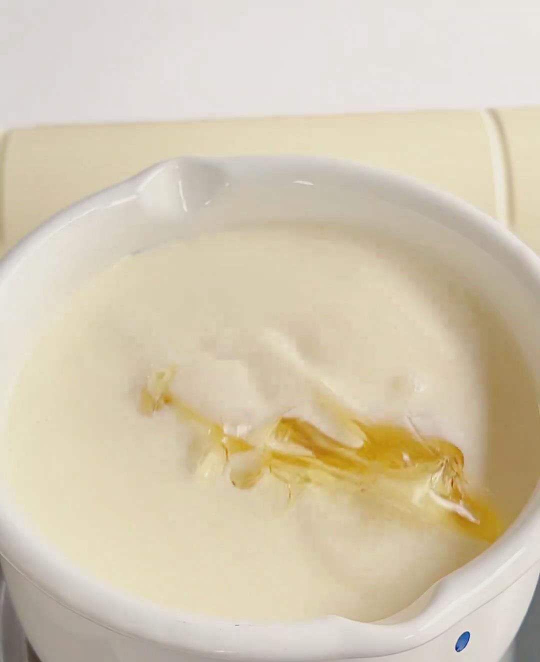 Squeeze softened gelatin sheets to remove excess water, then whisk into the warm milk mixture until completely dissolved