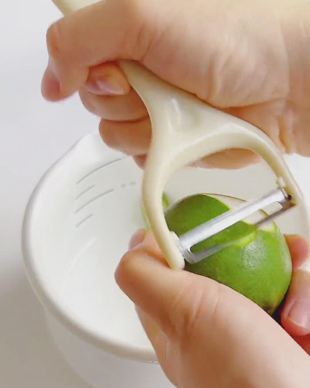 Use a peeler or zester to remove only the green outer peel