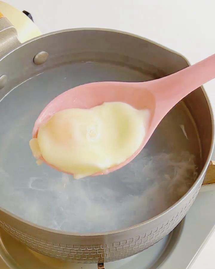 Use a slotted spoon to remove the poached egg