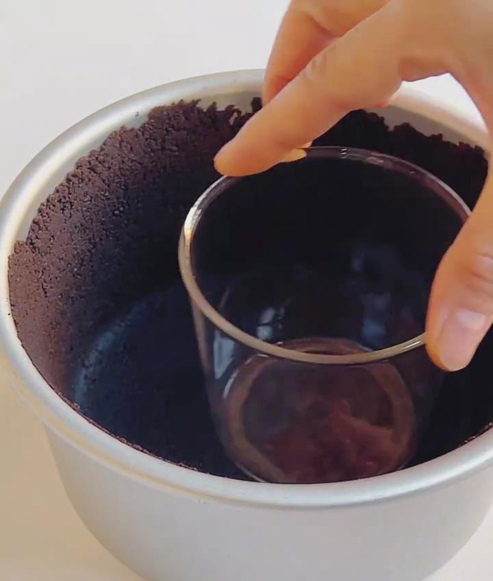 Use the flat bottom of a measuring cup, glass, or spatula to press the crumbs firmly