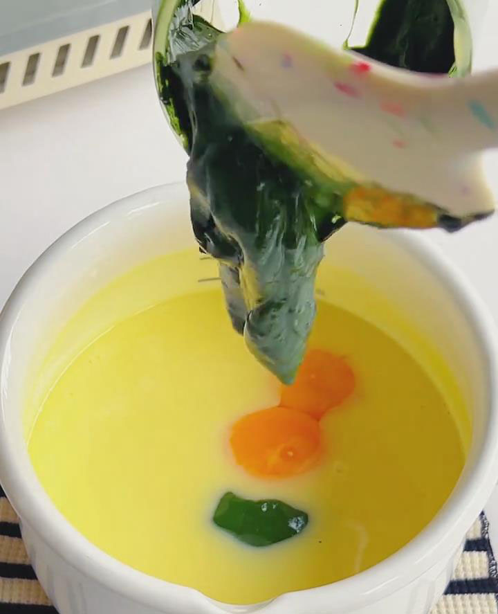 Whisk in the 2 egg yolks until fully incorporated. Then, slowly whisk in the prepared matcha paste until the mixture is uniformly green