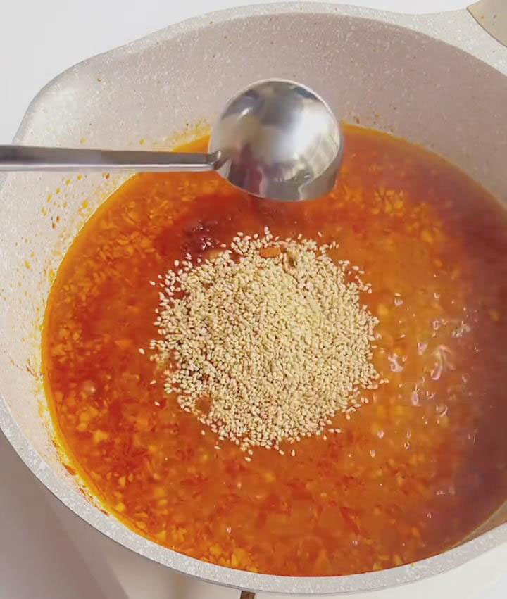 add the chili powder, sesame seeds, five spice powder, cumin seeds, and sweetener