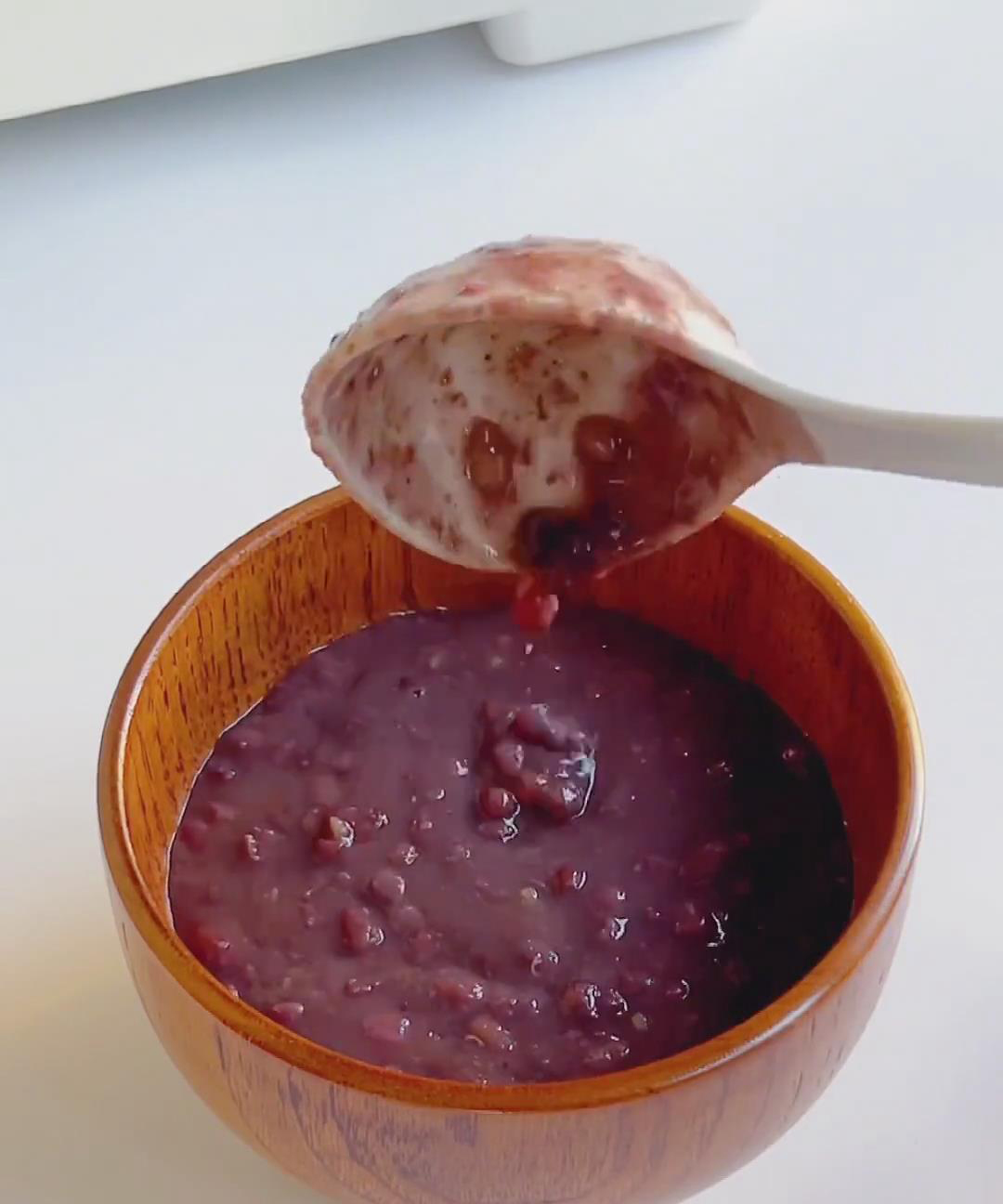 Scoop the warm red bean paste into serving bowls