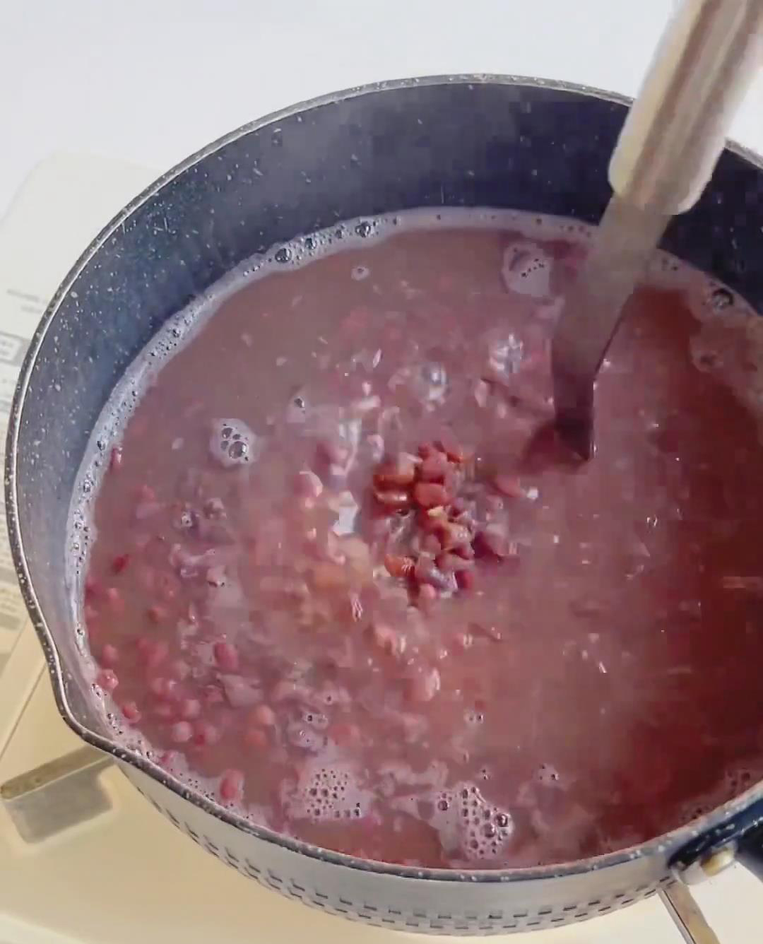 Use a masher to gently crush the cooked beans