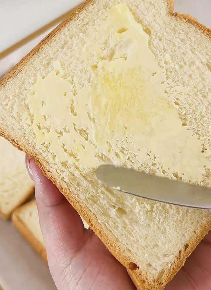 Lightly brush one side of each white bread slice with a thin layer of softened butter