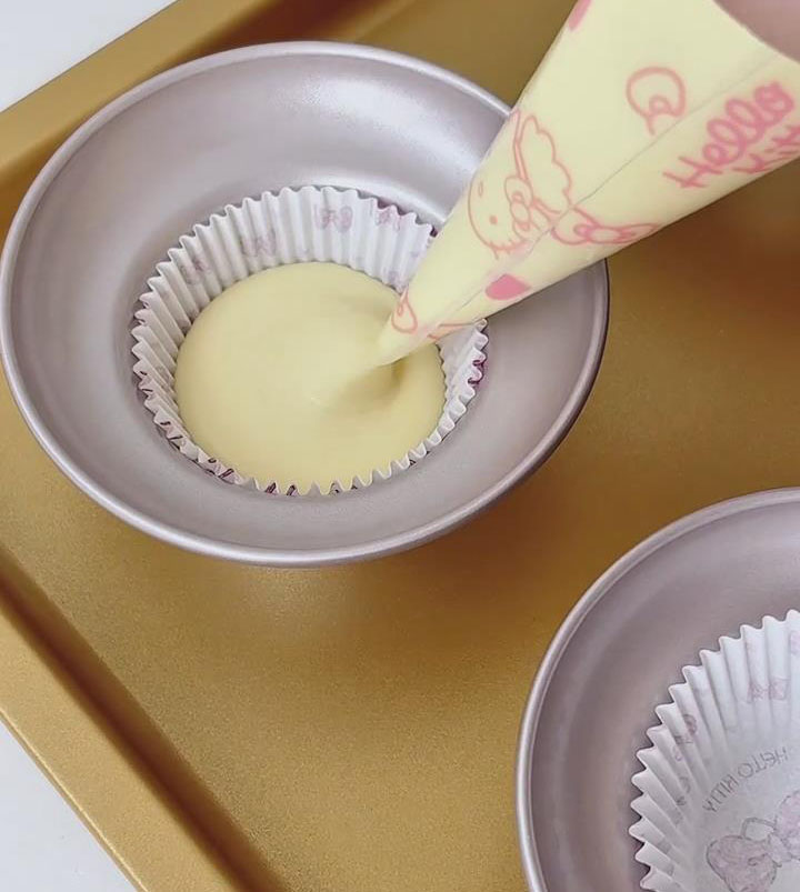 Pipe the batter into the prepared muffin cups