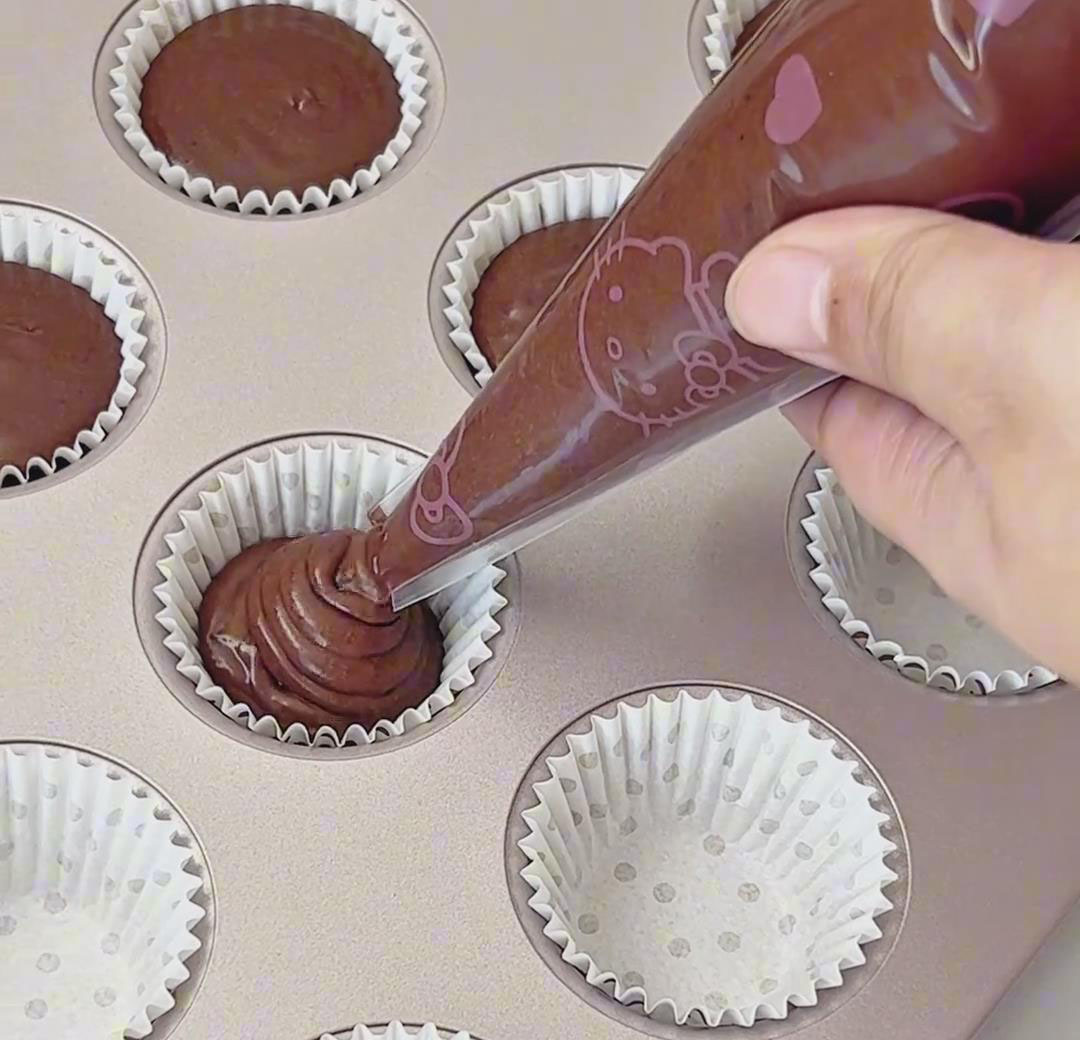 Pipe the batter into the prepared muffin molds