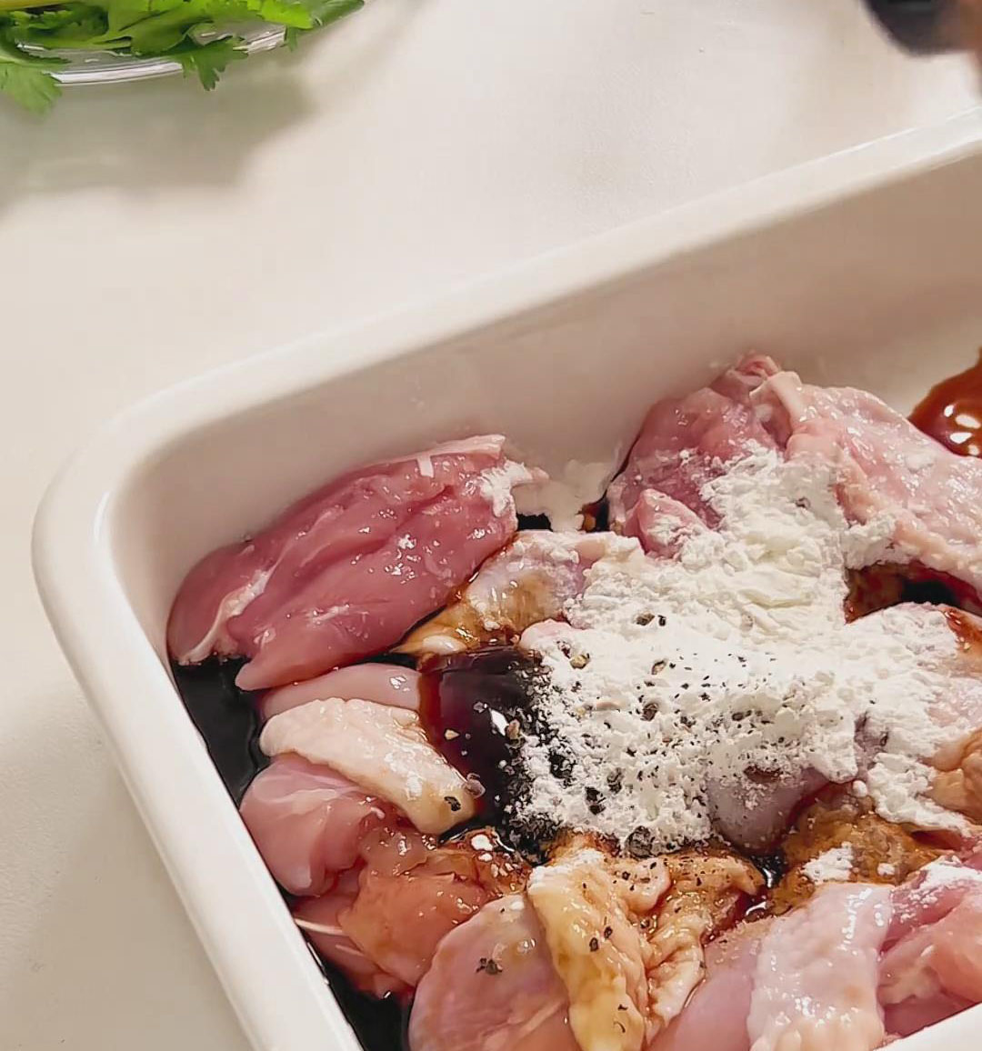 Place the chicken in a large bowl and add the light soy sauce, dark soy sauce, oyster sauce, cornstarch, salt, and black pepper