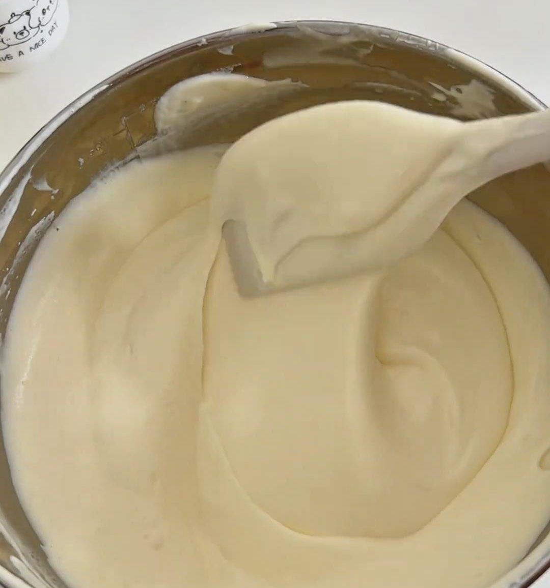 continue folding gently with an under and over motion until the batter is glossy and uniform