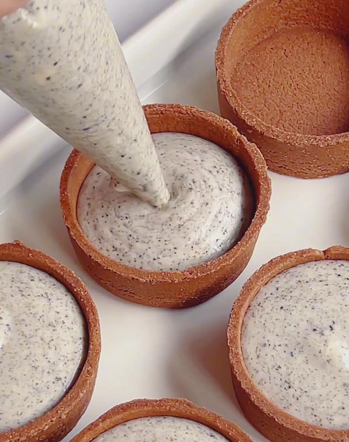 pipe the cheesecake filling into the cocoa tart shells